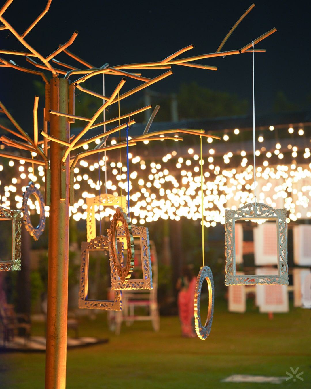 String-light trees lining the walk to the floor